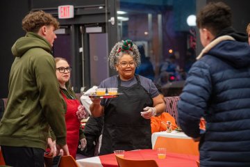Students waited on by faculty and staff at the 2025 Holiday Dinner.
