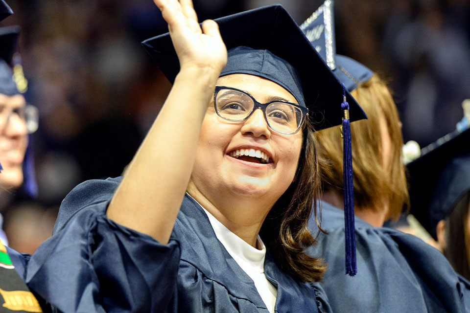 Utica University graduate smiling on