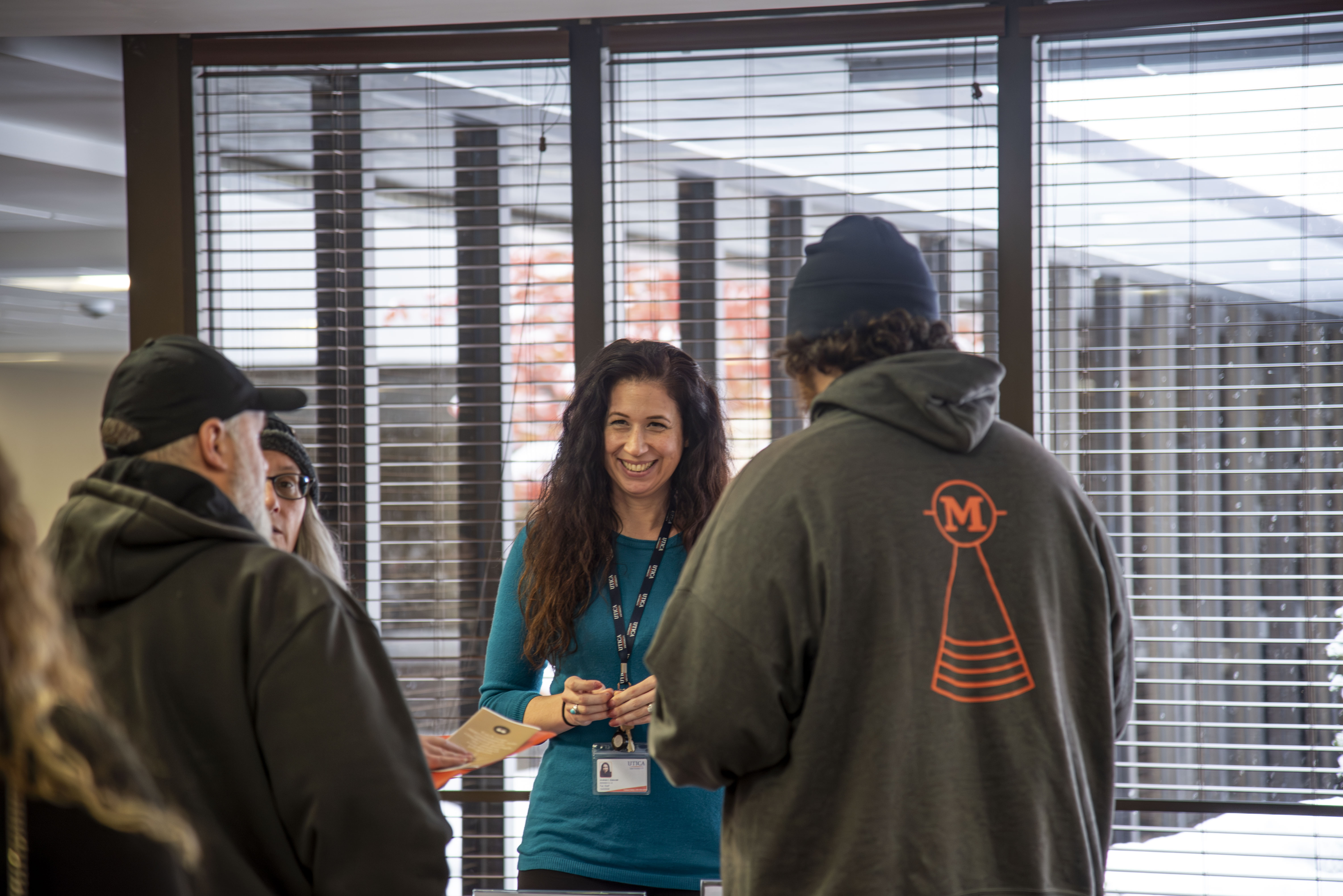 Members of the Utica community chat with prospective students and their families at a November 2025 Open House event.