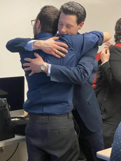 Members of the Utica Mock Trial team share an emotional moment at the 2023 regionals.