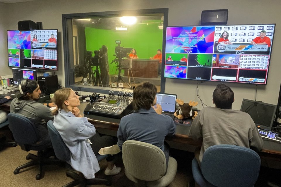 Students in control room producing a TV broadcast program.