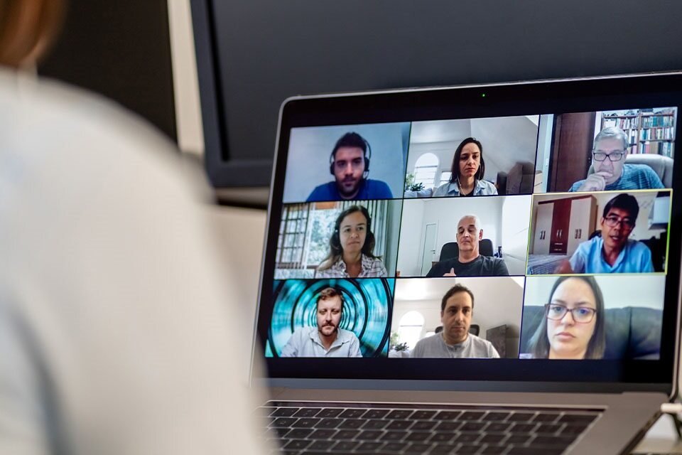 A person on a zoom call, with the small class, as they learn from home.  